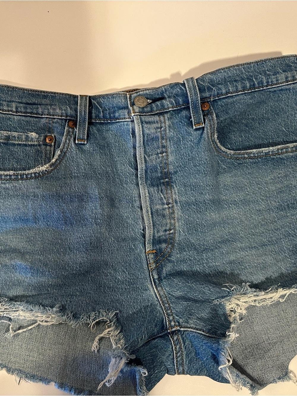 Levi 501 Button Fly Denim Jean Shorts with Frayed Edge.